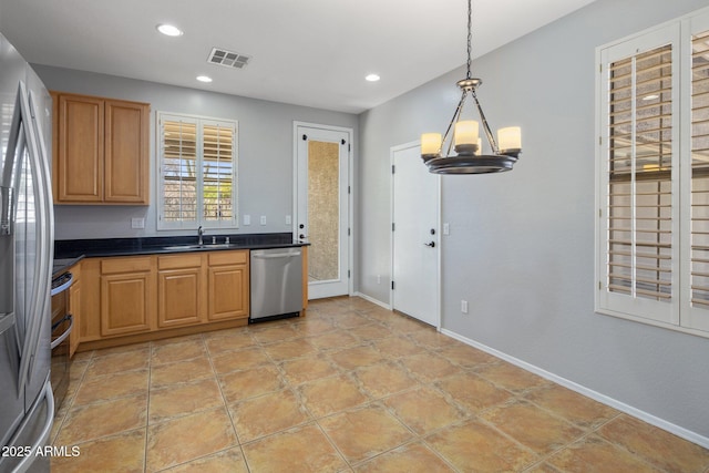 kitchen with visible vents, dark countertops, a sink, stainless steel appliances, and recessed lighting