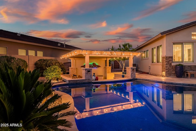 31108 N 122nd Ln, Peoria, AZ 85383 - pool at dusk featuring a patio area, an outdoor pool, a fenced backyard, and area for grilling