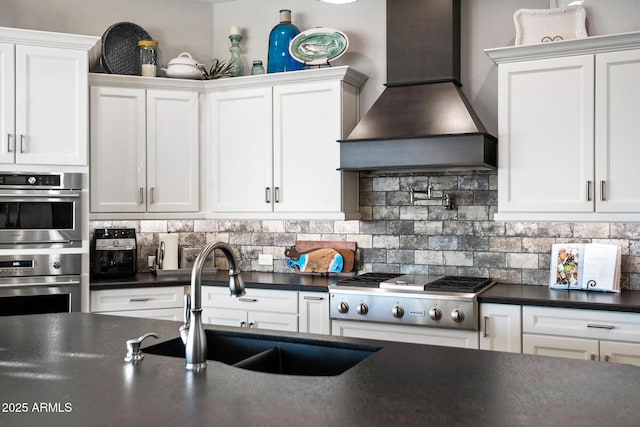 31108 N 122nd Ln, Peoria, AZ 85383 - kitchen featuring custom exhaust hood, a sink, dark countertops, appliances with stainless steel finishes, and white cabinetry
