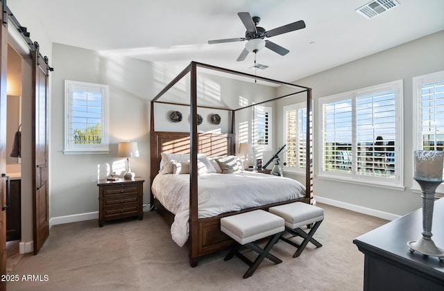 31108 N 122nd Ln, Peoria, AZ 85383 - carpeted bedroom featuring a barn door, multiple windows, and baseboards