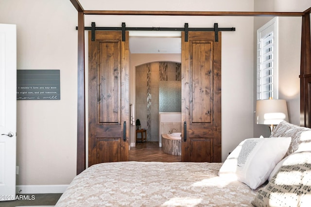 31108 N 122nd Ln, Peoria, AZ 85383 - bedroom featuring a barn door and baseboards