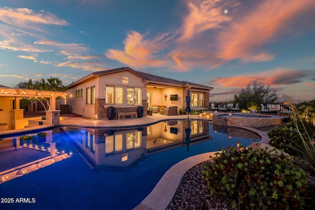 31108 N 122nd Ln, Peoria, AZ 85383 - pool at dusk with an in-ground hot tub, a patio, and an outdoor living space