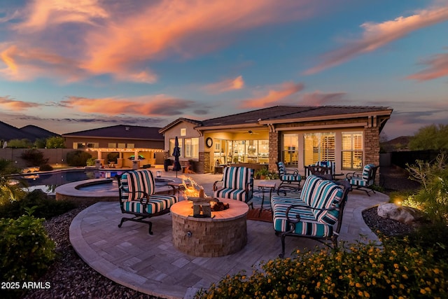 31108 N 122nd Ln, Peoria, AZ 85383 - view of patio / terrace featuring a fenced backyard, an outdoor living space with a fire pit, and an in-ground hot tub