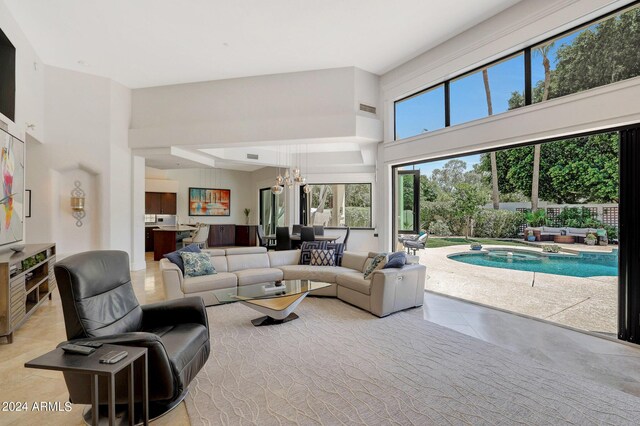 tiled living room with an inviting chandelier