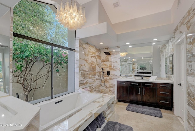 bathroom featuring vanity, expansive windows, a towering ceiling, shower with separate bathtub, and a notable chandelier