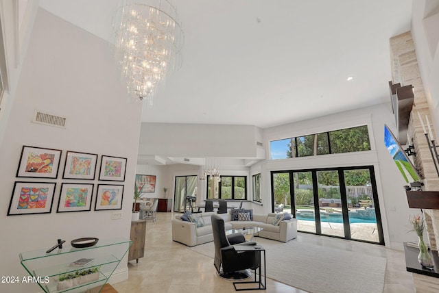 living room featuring a notable chandelier, a high ceiling, and french doors