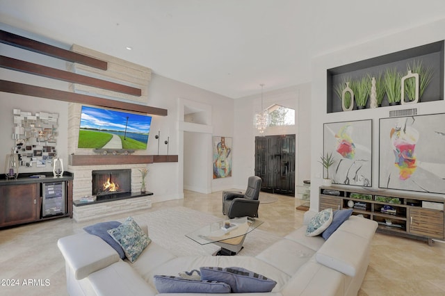 living room featuring a fireplace, beverage cooler, and a high ceiling