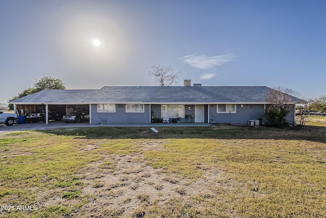 ranch-style home with an attached carport and a front lawn