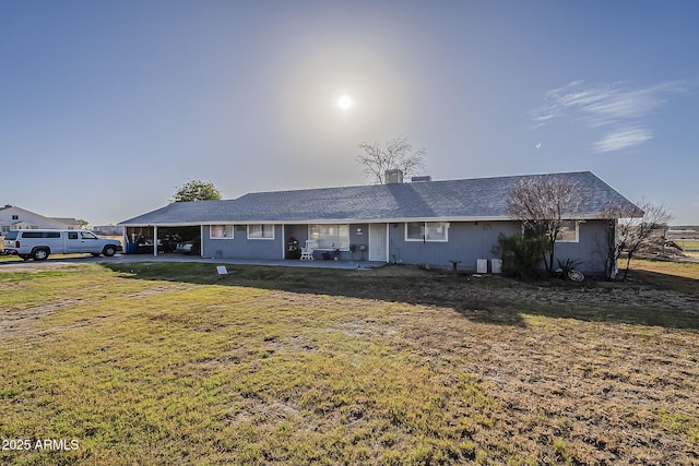 single story home featuring a carport, a front yard, and cooling unit