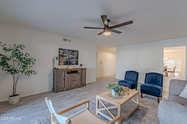 living room featuring ceiling fan and light hardwood / wood-style flooring