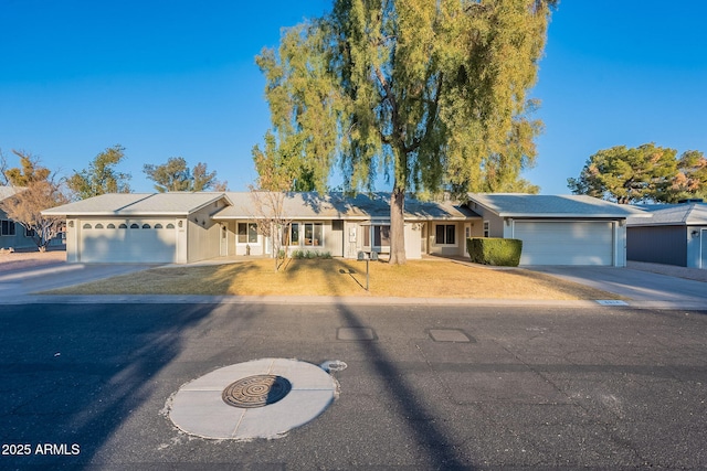 ranch-style house with a garage and a front lawn