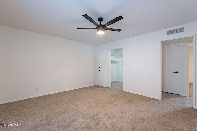 spare room featuring ceiling fan and light colored carpet