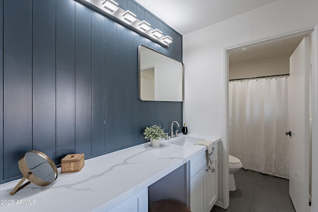 bathroom featuring tile patterned floors, toilet, and vanity