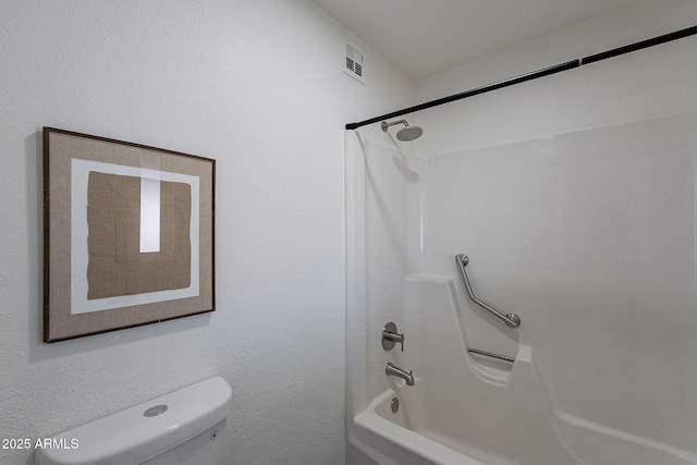 bathroom with shower / bathtub combination and toilet