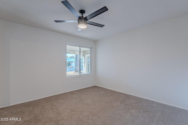 spare room featuring carpet floors and ceiling fan