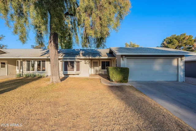 ranch-style house with a garage and a front yard