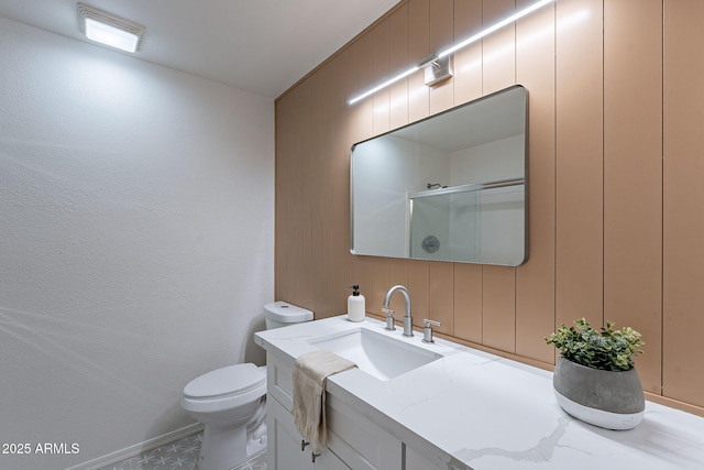 bathroom featuring vanity, an enclosed shower, and toilet