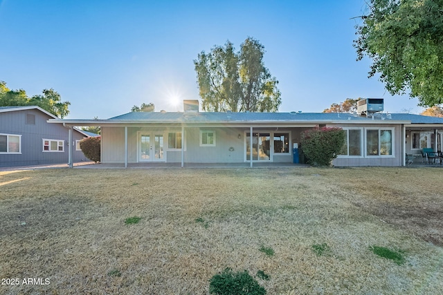 back of house with french doors, a patio, central AC unit, and a lawn