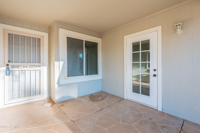 view of exterior entry with a patio area