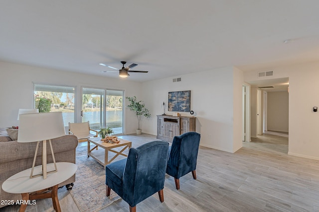 living room featuring light hardwood / wood-style floors and ceiling fan