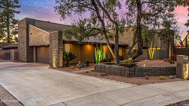 pueblo-style home with a garage