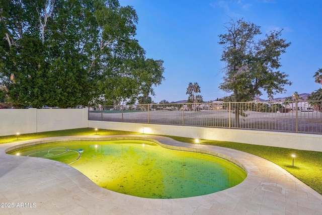 view of pool at dusk