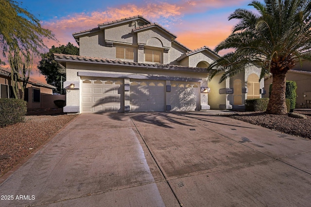 mediterranean / spanish house featuring a garage