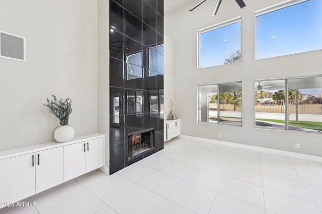 living room featuring a fireplace and light tile patterned floors