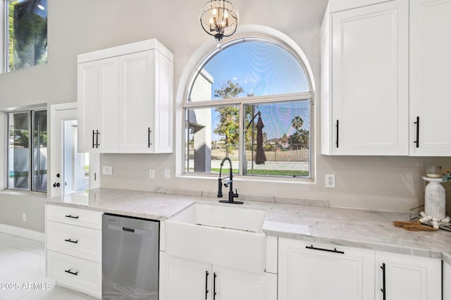 kitchen featuring sink, white cabinets, dishwasher, light stone countertops, and a notable chandelier