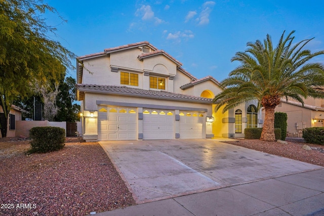 mediterranean / spanish home with a garage