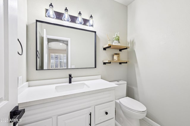 bathroom featuring vanity and toilet