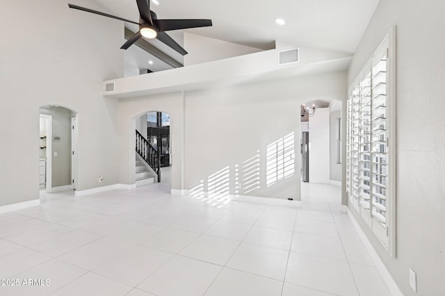 interior space featuring ceiling fan and high vaulted ceiling