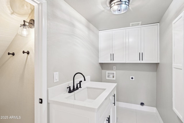 laundry room with hookup for an electric dryer, light tile patterned floors, hookup for a washing machine, cabinets, and sink