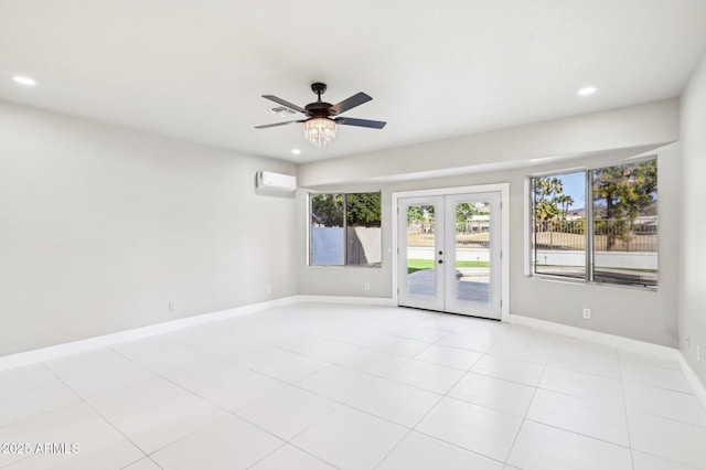 empty room featuring french doors, ceiling fan, light tile patterned floors, and a wall mounted air conditioner