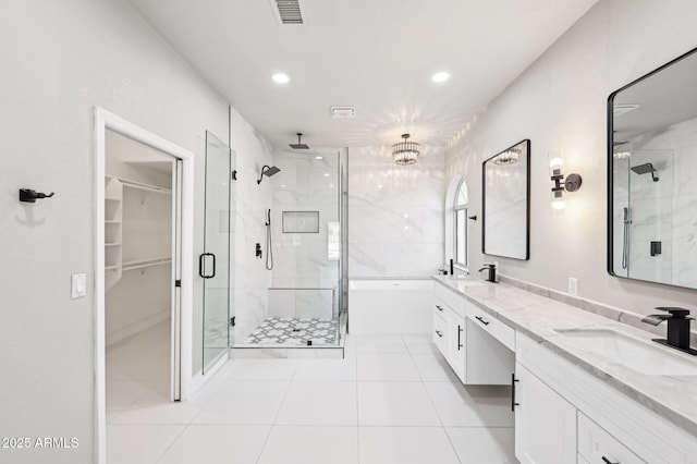 bathroom featuring tile patterned flooring, separate shower and tub, and vanity