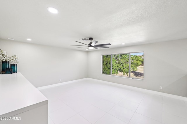 spare room with a textured ceiling and ceiling fan