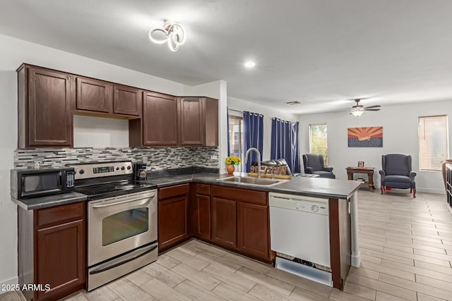 7725 S 47th Ln, Laveen, AZ 85339 - kitchen featuring stainless steel electric range oven, dishwasher, black microwave, open floor plan, and dark countertops