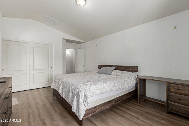 7725 S 47th Ln, Laveen, AZ 85339 - bedroom with wood finished floors, a closet, and lofted ceiling