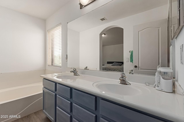 7725 S 47th Ln, Laveen, AZ 85339 - bathroom featuring double vanity, a bath, and connected bathroom