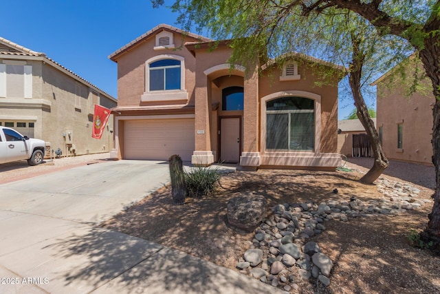 7725 S 47th Ln, Laveen, AZ 85339 - mediterranean / spanish house featuring stucco siding, driveway, an attached garage, and a tiled roof