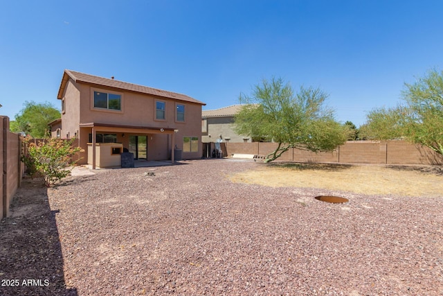 7725 S 47th Ln, Laveen, AZ 85339 - rear view of house with stucco siding, a fenced backyard, and a patio