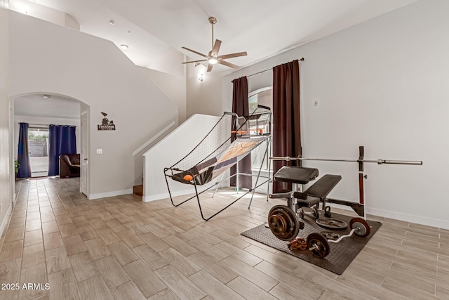7725 S 47th Ln, Laveen, AZ 85339 - exercise room featuring arched walkways, a ceiling fan, and wood tiled floors