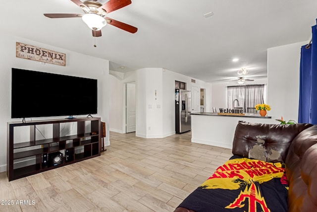 7725 S 47th Ln, Laveen, AZ 85339 - living room with a ceiling fan and light wood-style flooring