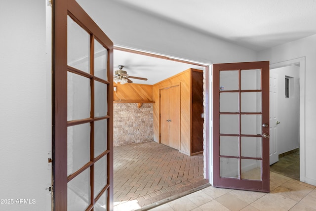 corridor featuring wood walls