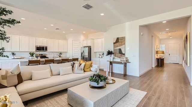 23244 W Tamarisk Ave, Buckeye, AZ 85326 - living area featuring light wood finished floors and recessed lighting