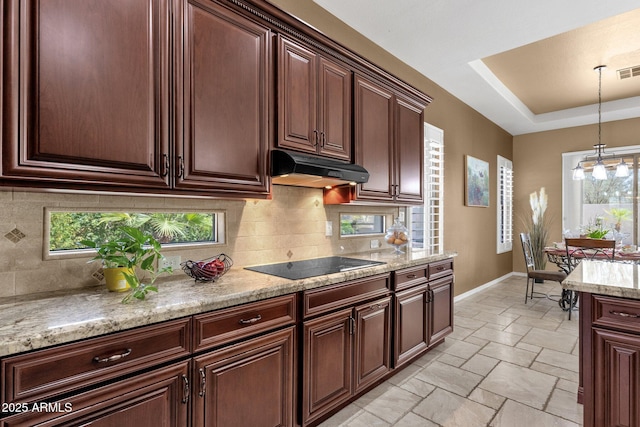 5342 S Citrus Ct, Gilbert, AZ 85298 - kitchen featuring under cabinet range hood, black electric stovetop, tasteful backsplash, and baseboards