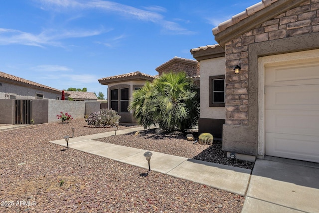 5342 S Citrus Ct, Gilbert, AZ 85298 - entrance to property featuring a tile roof, stucco siding, a garage, and stone siding