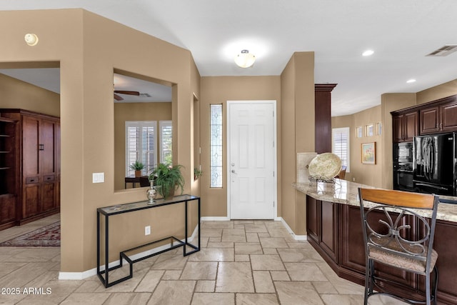 5342 S Citrus Ct, Gilbert, AZ 85298 - entrance foyer with baseboards, ceiling fan, healthy amount of natural light, and stone tile flooring