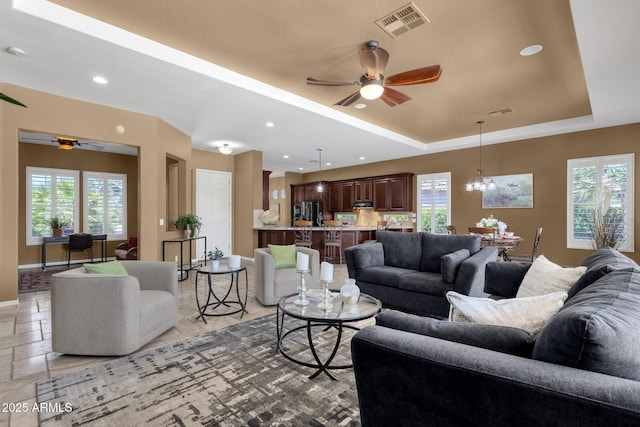 5342 S Citrus Ct, Gilbert, AZ 85298 - living room with ceiling fan, a tray ceiling, recessed lighting, a chandelier, and baseboards