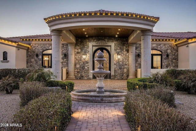 property entrance with a tile roof